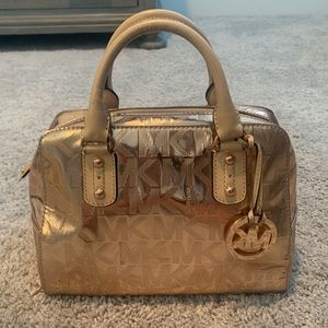 Michael Kors rose gold purse with zipper